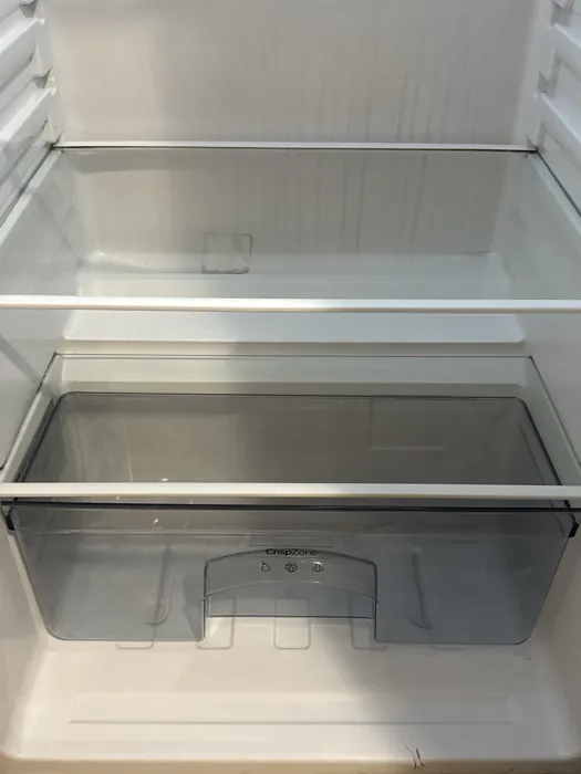 Empty refrigerator interior cleaned out for a move-out handover