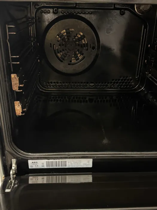 Oven interior after cleaning, fan guard and side rails clear of residue